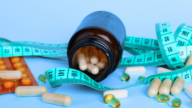 a bottle of medication lays open on a table with a tape measure